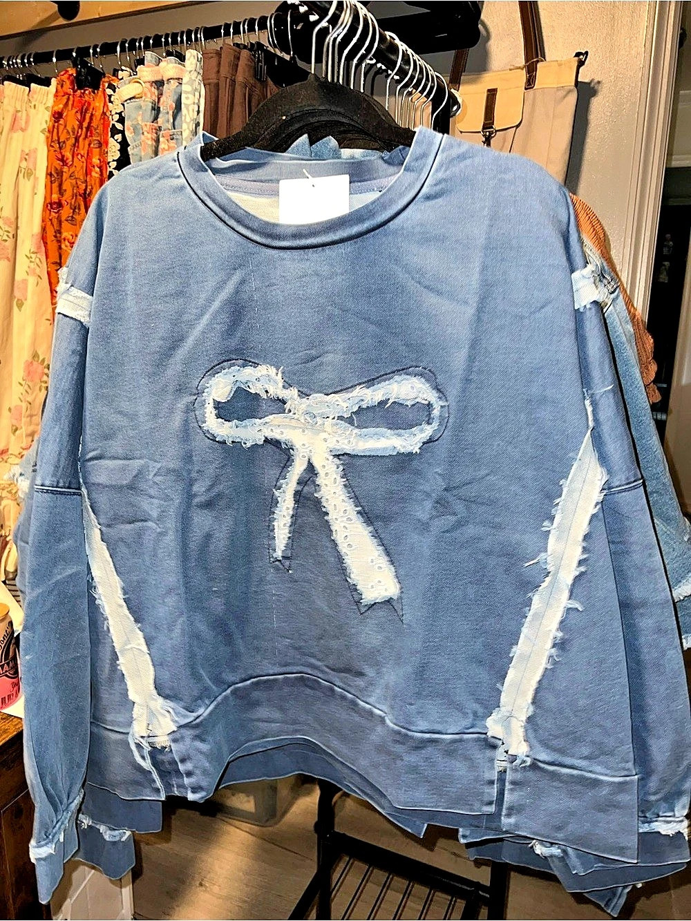 Heimish Eyelet Bow Applique Raw Edge Denim Sweatshirt